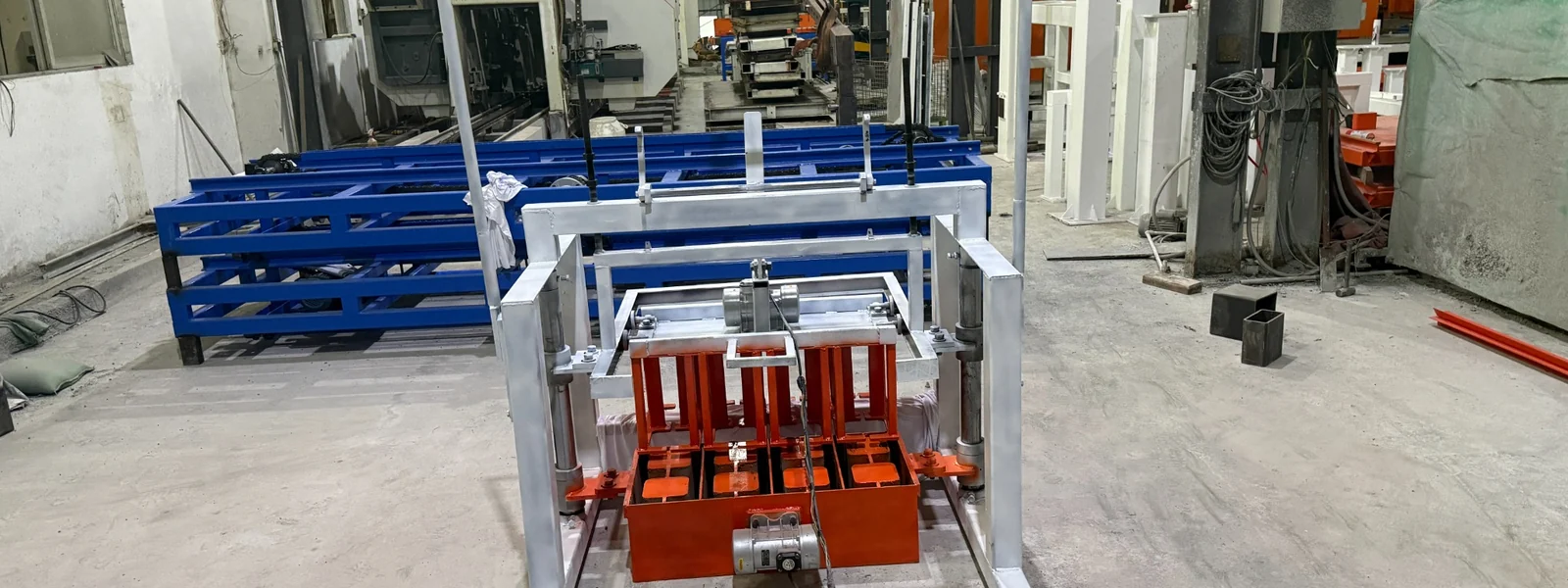 Manual hollow block machine with white steel frame and orange mold area